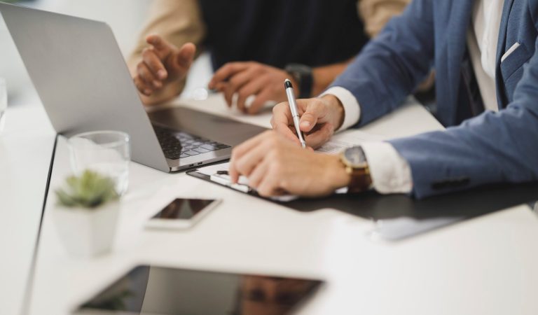 People taking notes in an interview